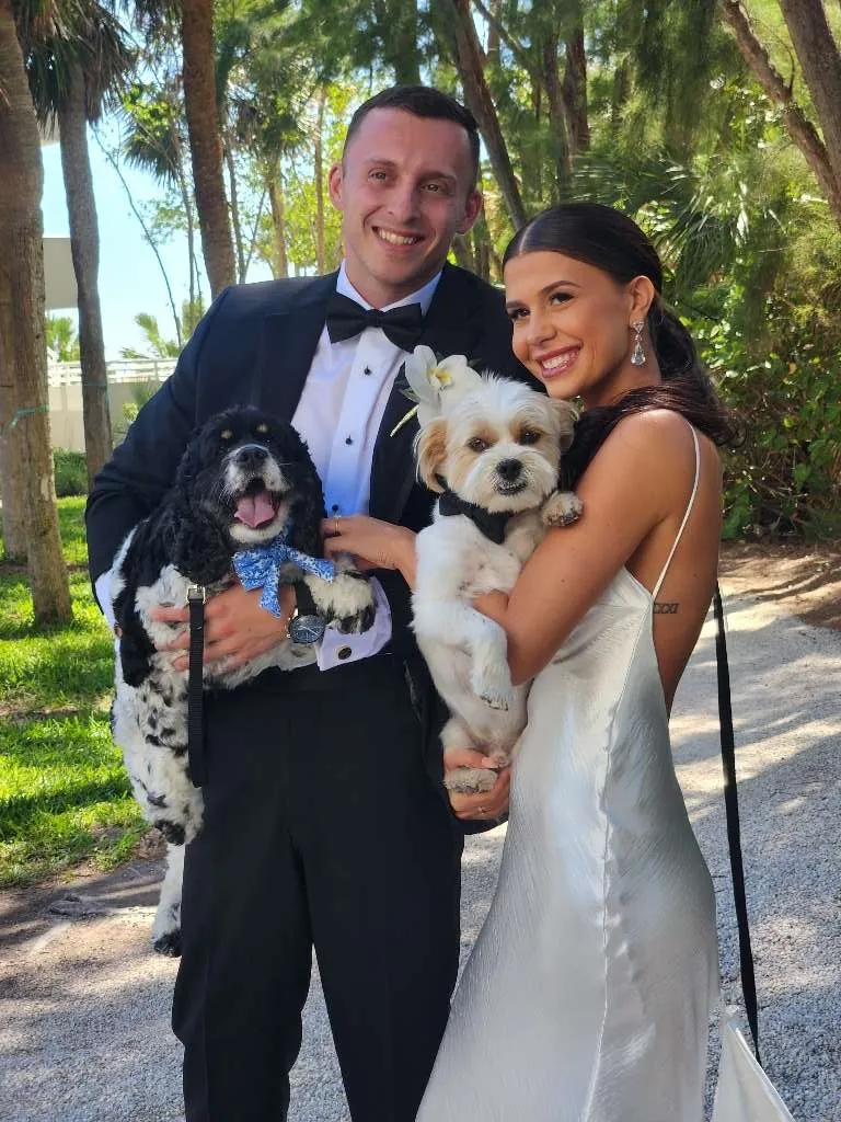 Dog at outdoor wedding ceremony with attendant